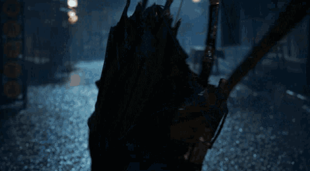 a man with a bow and arrow on his back is looking at the camera