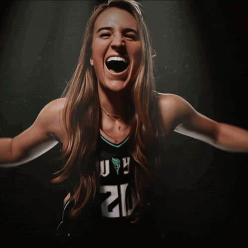 a woman wearing a jersey with the number 21 on it screams