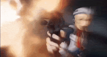 a person is holding a gun in their hand in a dark room .