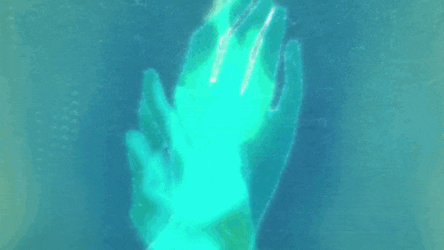 a person with their eyes closed is reaching out with their hand