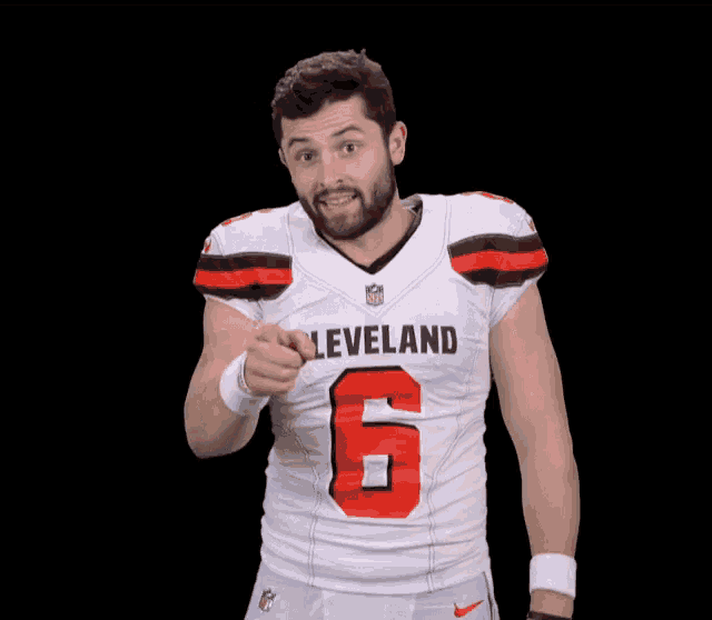 a man is wearing a cleveland football jersey