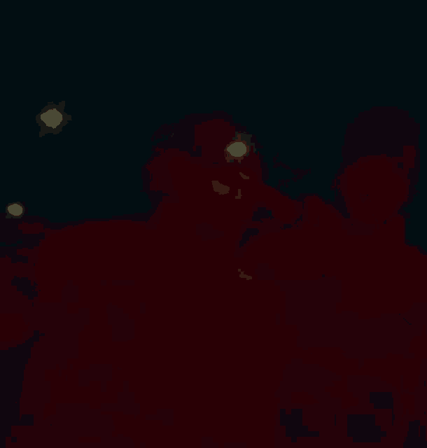 a blurry picture of a person in a red hoodie