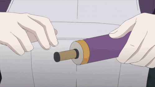 a person is holding a purple object with a black tip