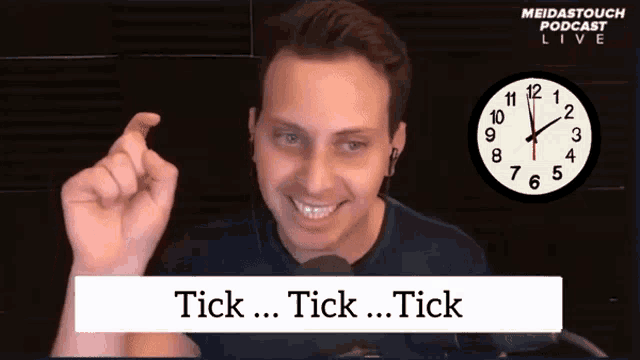 a man is smiling in front of a clock that says meidastouch podcast live on it