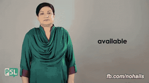 a woman in a green shirt is standing in front of a sign that says available