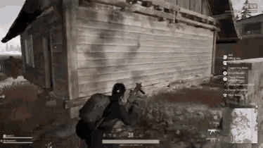 a man is holding a gun in front of a wooden building and the number 38 is on the screen