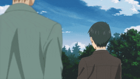 a man in a suit and a man in a green jacket are standing next to each other