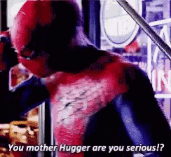 a man in a spiderman costume is standing in front of a store .