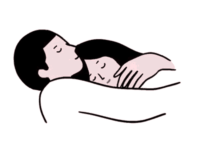 a man and a woman are laying next to each other and kissing .