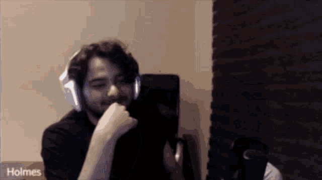 a man wearing headphones with the word holmes on the bottom