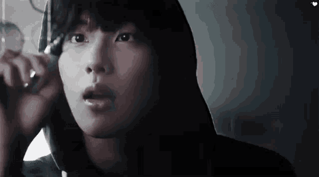 a close up of a person wearing a hooded jacket .