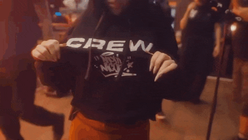 a person wearing a hoodie that says crew