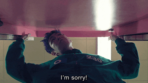 a man in a green jacket with the number 230 on it says " i 'm sorry "