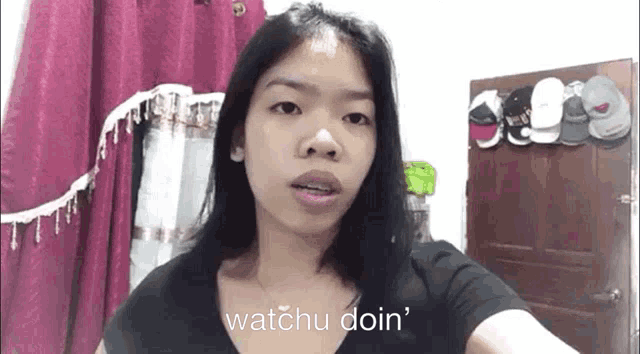 a woman taking a selfie with the words watchu doin ' on the bottom of her face
