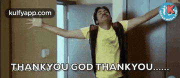 a man is standing in front of a door with his arms outstretched and says `` thank you god thank you '' .