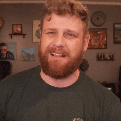 a man with a beard is wearing a green t-shirt that says texas state