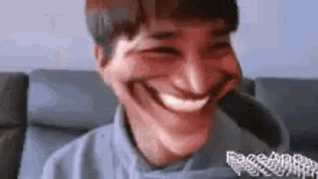 a man is making a funny face with his mouth open .