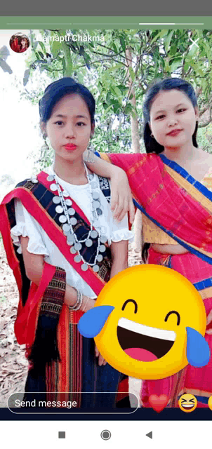 two girls are posing for a picture with a yellow smiley face in the foreground that says send message