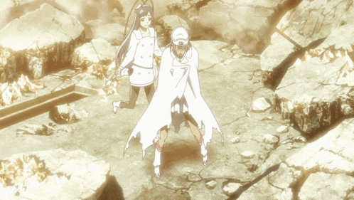 a man and a woman are standing in a rocky area