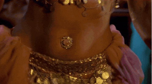 a close up of a woman 's belly with a necklace on it .