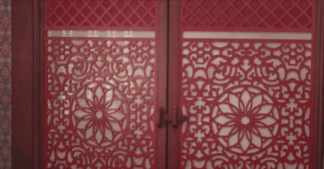 a red door with a floral design on it is open