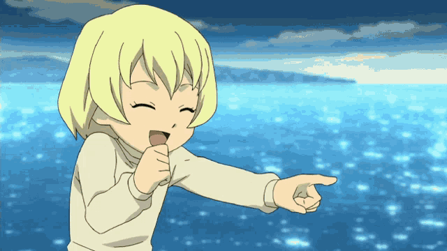 a little girl with blonde hair is pointing at something