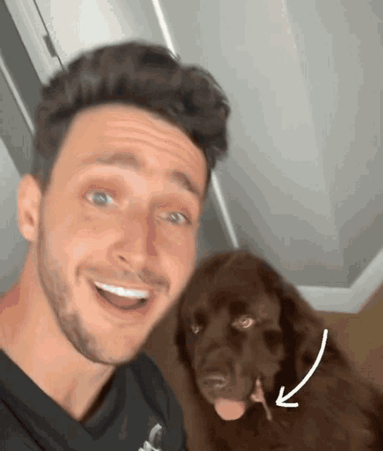 a man and his dog are posing for a picture with an arrow pointing to the dog 's tongue