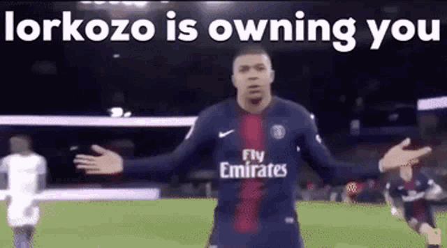 a soccer player wearing a fly emirates jersey is on a field .