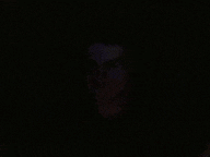 a man is wearing headphones in a dark room .