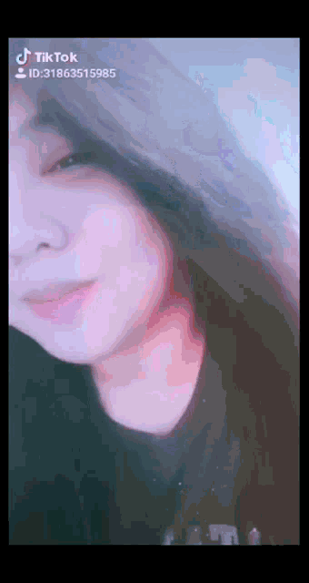 a close up of a woman 's face with tiktok written on the bottom