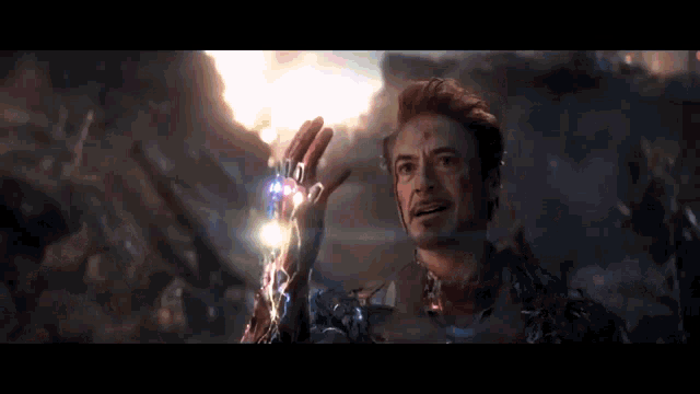 iron man is holding a lightning bolt in his hand in avengers endgame .