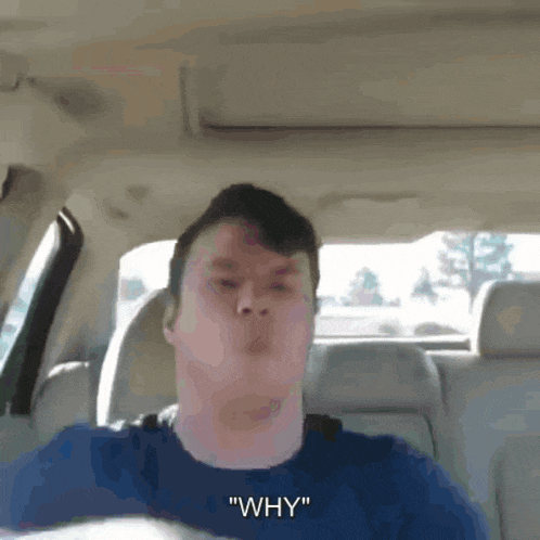 a man in a car says " why " while making a funny face