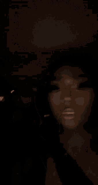 a blurry photo of a person 's back in the dark