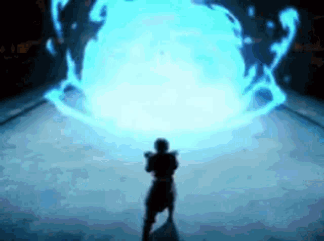 a silhouette of a person standing in front of a blue light .