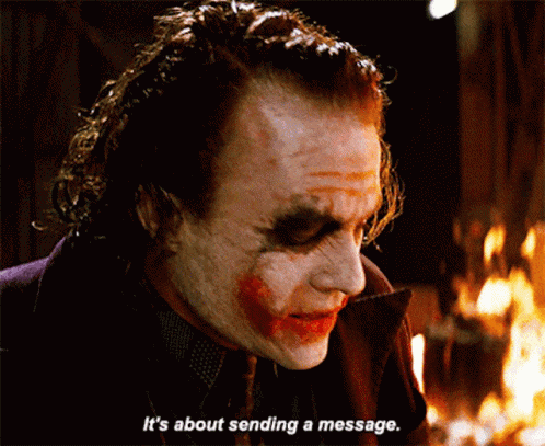 joker says it 's about sending a message in front of a fire