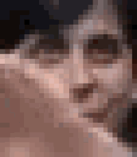 a close up of a man 's face with his hand on his chin and a blurry background .