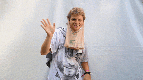 a man wearing a t-shirt with a picture of a man and a bag that says " fresh to go " on it