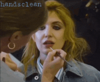 a close up of a woman getting her makeup done with the words handsclean in the background