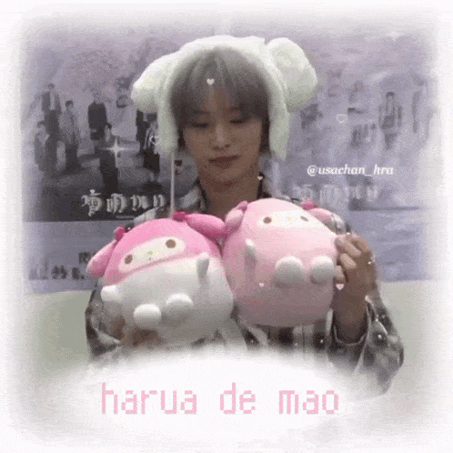 a girl is holding two stuffed animals and the words harua de mao are on the bottom