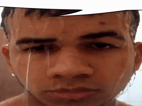 a close up of a man 's face with water running down his eye