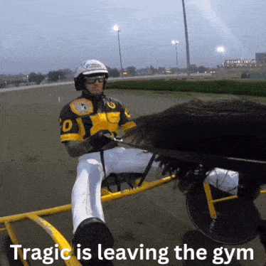 a man riding a horse drawn carriage with the words tragic is leaving the gym below him