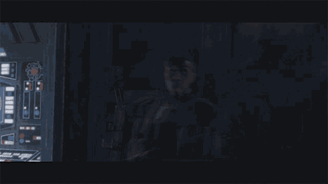 two soldiers are standing in a dark room and one has a skull on his chest