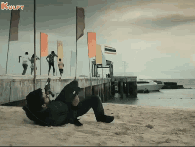 a man is laying on the beach with the words kulfy written on the bottom