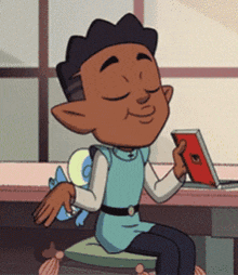 a cartoon boy is sitting at a table with a book and a laptop
