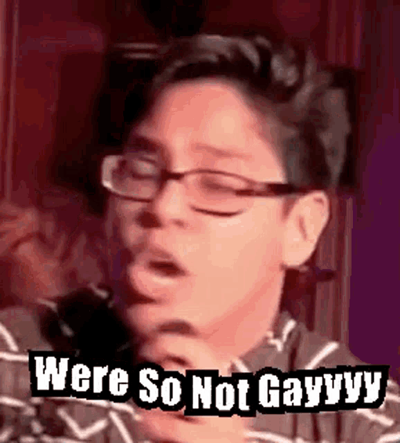 a man wearing glasses is making a funny face and saying `` were so not gayvvy '' .