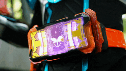 a person is wearing an orange belt with a purple item on it that says ' h ' on it