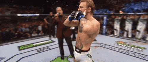 a man in a boxing ring with ufc written on the floor