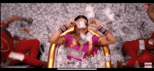 a woman in a pink dress is surrounded by money