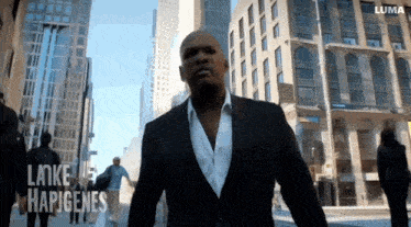 a man in a suit walks down a city street with the words lake hapigenes on the bottom left