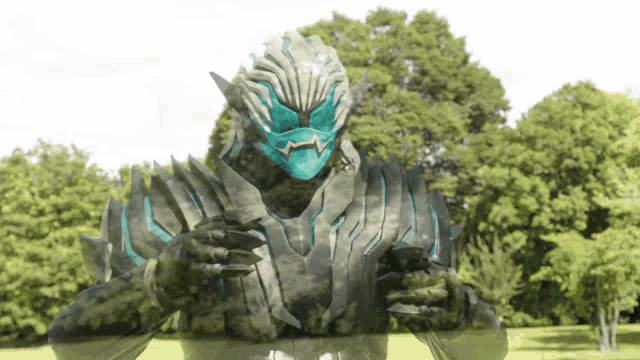 a monster with a blue mask is standing in front of trees